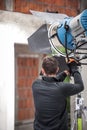 Behind the scene. Filmmaking lighting technician adjusting and setup lights Royalty Free Stock Photo