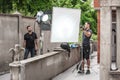 Behind the scene. Filmmaking lighting technician adjusting and setup lights Royalty Free Stock Photo