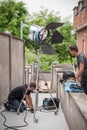 Behind the scene. Filmmaking lighting technician adjusting and setup lights Royalty Free Stock Photo