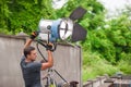 Behind the scene. Filmmaking lighting technician adjusting and setup lights Royalty Free Stock Photo