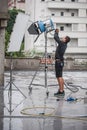 Behind the scene. Filmmaking lighting technician adjusting and setup lights Royalty Free Stock Photo