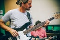 Behind scene. Guitarist practice playing guitar in messy music s Royalty Free Stock Photo