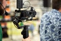 Behind the scenes of filming movies or video products. The operator with the camera on the set selects the shooting shot