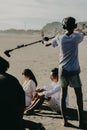 Behind the scenes of movie shooting or video production and film crew team with camera equipment at outdoor location. Royalty Free Stock Photo