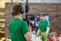 Behind the scenes of movie shooting or video production and film crew team with camera equipment at outdoor location. Royalty Free Stock Photo