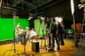 Behind-the-scenes at a TV studio filming a show with a camera crew