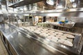 Behind the scenes view of food preparation in the kitchen, galley on board a large cruise ship at Sea in Queen Victori Royalty Free Stock Photo