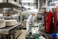 Behind the scenes view of food preparation in the kitchen, galley on board a large cruise ship at Sea in Queen Victoria