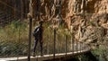 Behind shot of a tourist crossing the suspension bridge in Valencia, Spain on a sunny day