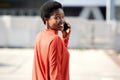 Behind of smiling African american woman talking on cellphone outdoors Royalty Free Stock Photo