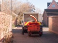 behind view of truck with red shredder machine behind street Royalty Free Stock Photo