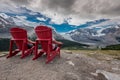 Behind View of Two People Sitting in Red Chairs Royalty Free Stock Photo