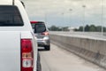 Behind a white pickup truck drives on a highway.