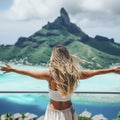 From behind, you can see the traveler girl arms spread wide as she take in the incredible view of Bora Bora Royalty Free Stock Photo