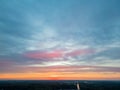 Aerial Drama: Colorful Sunset Under Clouded Sky