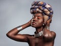 Behold her crowning beauty. Studio shot of a beautiful young woman wearing a traditional African head wrap against a