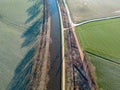 Winter Serenity: Aerial View of River or Canal Amidst Frozen Farm Fields