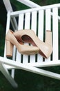 Beig shoes lie on the white garden chair Royalty Free Stock Photo