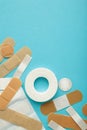 Beige adhesive bandages on blue background. Medical plasters. Vertical photo Royalty Free Stock Photo