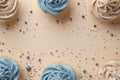 Beige background with blue cupcakes glitter and copy space. Its a boy backdrop with empty space for text. Baby shower Royalty Free Stock Photo