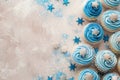 Beige background with blue cupcakes glitter and copy space. Its a boy backdrop with empty space for text. Baby shower Royalty Free Stock Photo