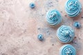 Beige background with blue cupcakes glitter and copy space. Its a boy backdrop with empty space for text. Baby shower Royalty Free Stock Photo