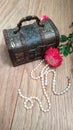 Wooden chest with white pearls and flowers Royalty Free Stock Photo