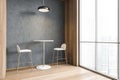 Beige bar chairs with table and light wooden partition near big window