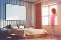 Beige bedroom with a large poster, side, girl Royalty Free Stock Photo