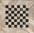 Beige and black marble mosaic chess board, empty textured backdrop Royalty Free Stock Photo