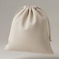 A beige, canvas drawstring bag is shown, with the drawstrings cinched at the top Royalty Free Stock Photo