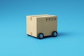 beige cardboard mail box with wheels isolated on blue background Royalty Free Stock Photo