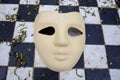 beige carnival mask on chequered background