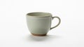 Beige ceramic cup with a smooth surface featuring a rounded handle Royalty Free Stock Photo