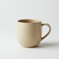 A beige ceramic mug with a rounded shape sits on a light surface. It features a curve Royalty Free Stock Photo