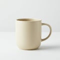 Beige ceramic mug with a smooth texture and rounded handle. The mug has a simple Royalty Free Stock Photo