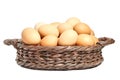 Beige chicken eggs in a brown wicker basket Royalty Free Stock Photo