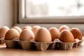 Beige chicken eggs in cardboard packaging on empty table Royalty Free Stock Photo
