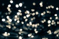 Beige christmas lights with blue green dark blur bokeh background Royalty Free Stock Photo