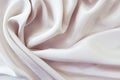 Beige color natural silk draped with folds, top view, fabric texture Royalty Free Stock Photo