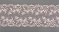 Color straight strip of lace fabric on a gray background. Elastic silk nylon braid border. use for clothes and linen decoration Royalty Free Stock Photo