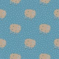 Beige colored sheep ornament seamless pattern. Doodle cartoon yarn print on blue dotted background