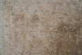 Beige colored wall with the cracked stucco texture background