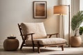 Beige comfortable, cozy armchair in a room with a lamp and home growths.