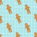 Beige cookies in gingerbread man shapes seamless doodle pattern. Winter stylized bakery tasty print on blue chequred background Royalty Free Stock Photo