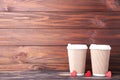 Beige cups of coffee and hearts on wooden brown background Royalty Free Stock Photo