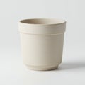 A beige, cylindrical ceramic pot with smooth texture and a wide rim. It has a consistent, Royalty Free Stock Photo