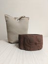 Door stopper bag behind brown concrete owl pot