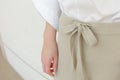 Beige draw string waist casual woman pants style close up details. Minimal trendy fashion.