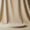 A beige fabric backdrop with a subtle texture drapes behind a low, round platform of Royalty Free Stock Photo